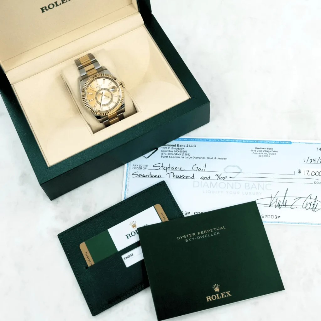 Reloj Rolex y un cheque de Diamond Banc
