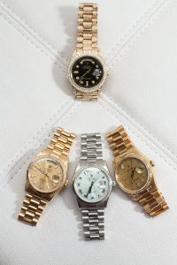 One Rolex President Yellow Gold watch on top and three Day-Date and Datejust Rolex on the bottom