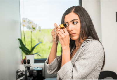 Professional woman looking at a diamond necklace