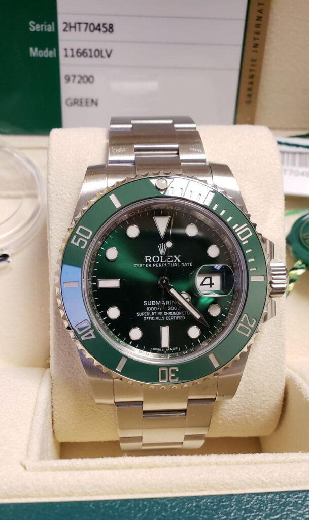 A Rolex Submariner Date Hulk watch displayed in a velvet-lined box, featuring a stainless steel bracelet and a date window.