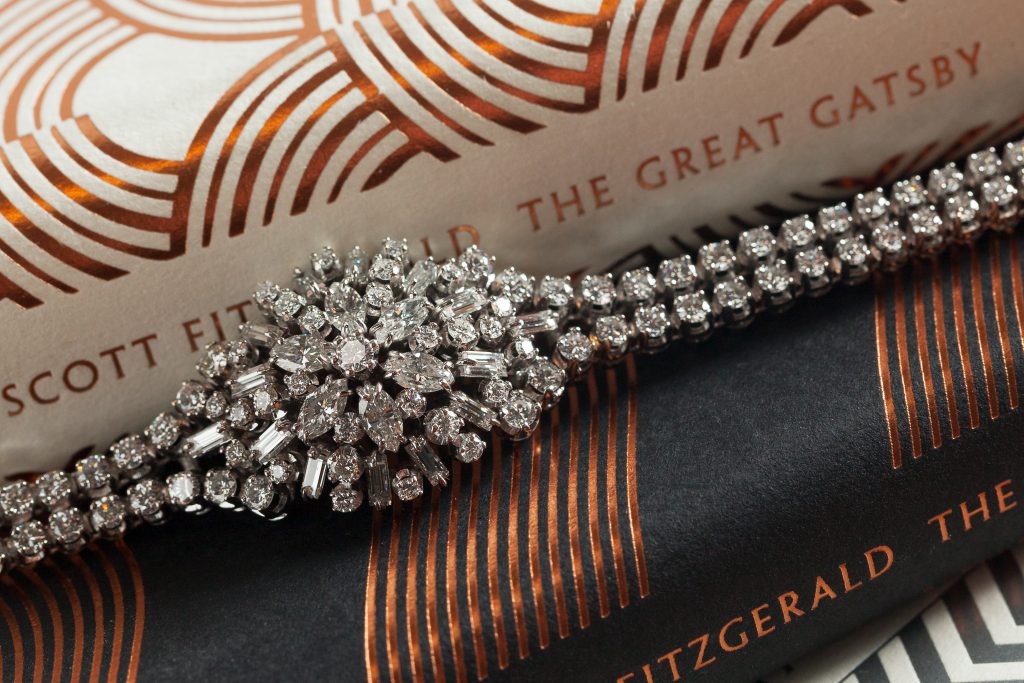 An elegant diamond bracelet on top of a book