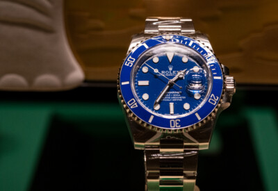 A close-up of a Rolex Submariner Smurf with a blue bezel and dial, silver hour markers, and a stainless steel bracelet—perfect for any discerning Rolex Buyer in Coral Gables.