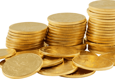 A close-up of several stacks and scattered gold coins, showcasing their shiny surface and intricate designs.
