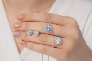 Woman selling diamond earrings, diamond necklace and diamond engagement ring