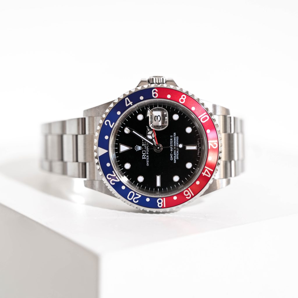 Rolex GMT Master II Pepsi Watch on edge of the white table