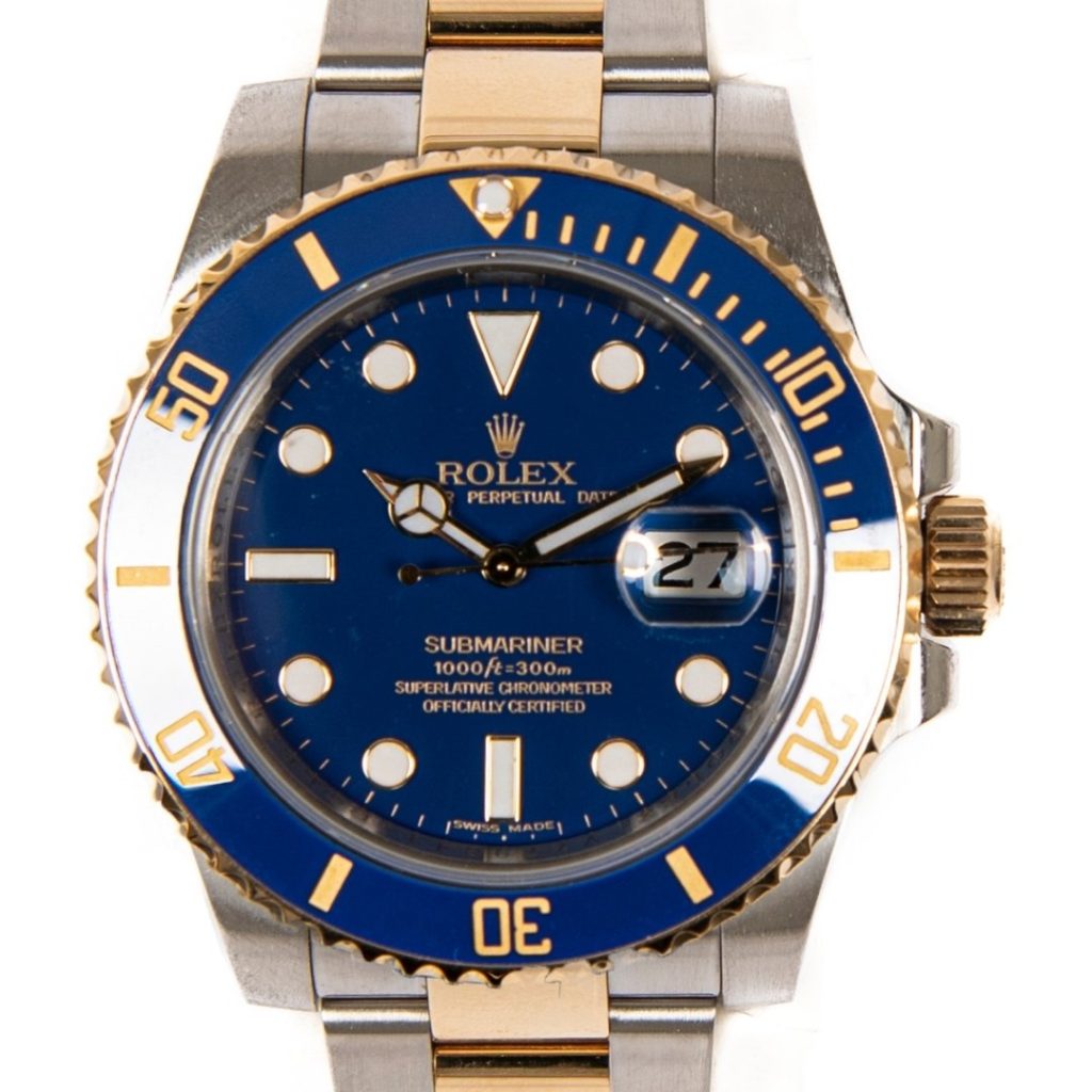 A Rolex Submariner watch featuring a blue dial, gold and silver band, and distinct hour markers, highlights its luxury design.