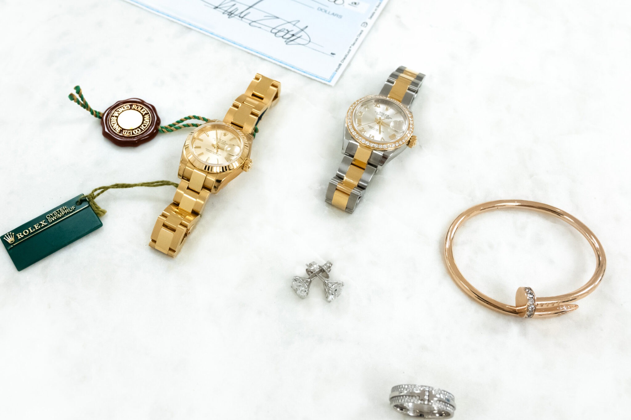 rolex watches and diamond jewelries with a check