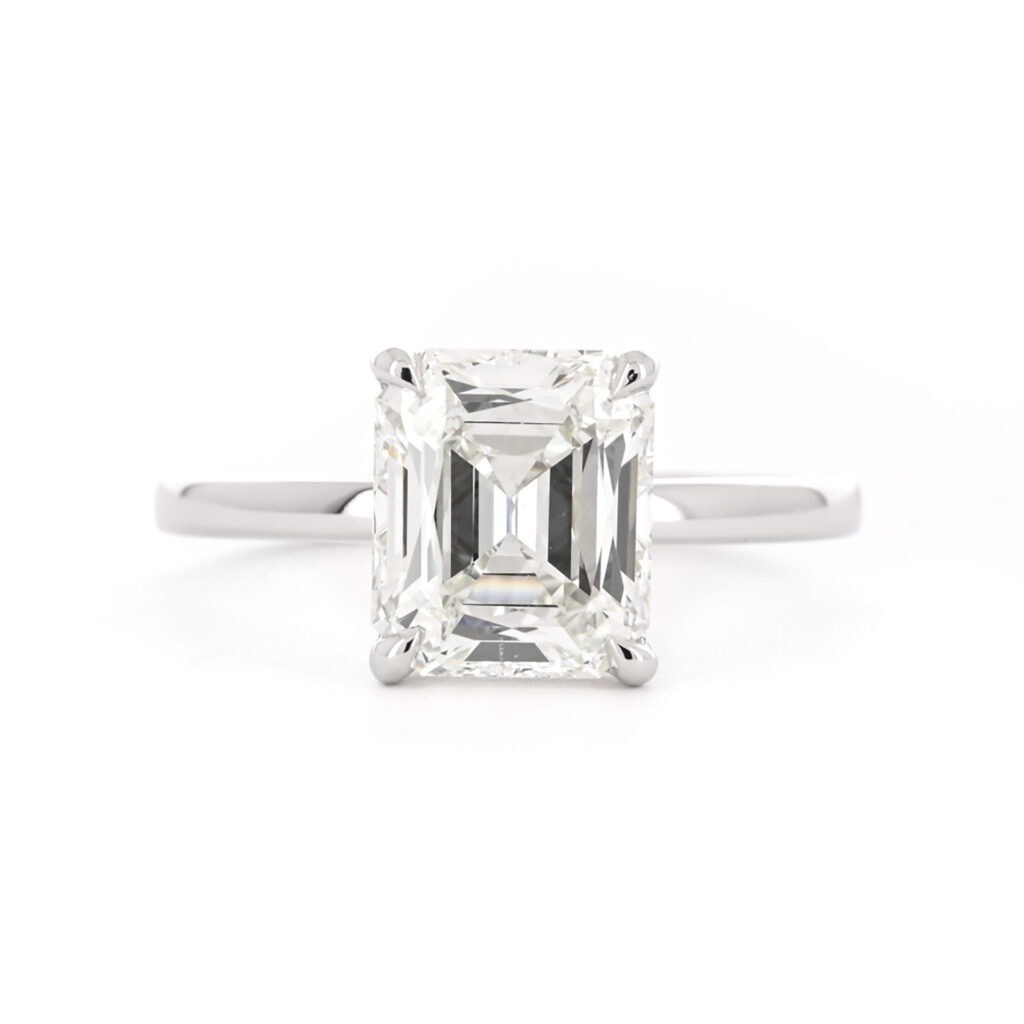 A solitaire emerald cut diamond ring