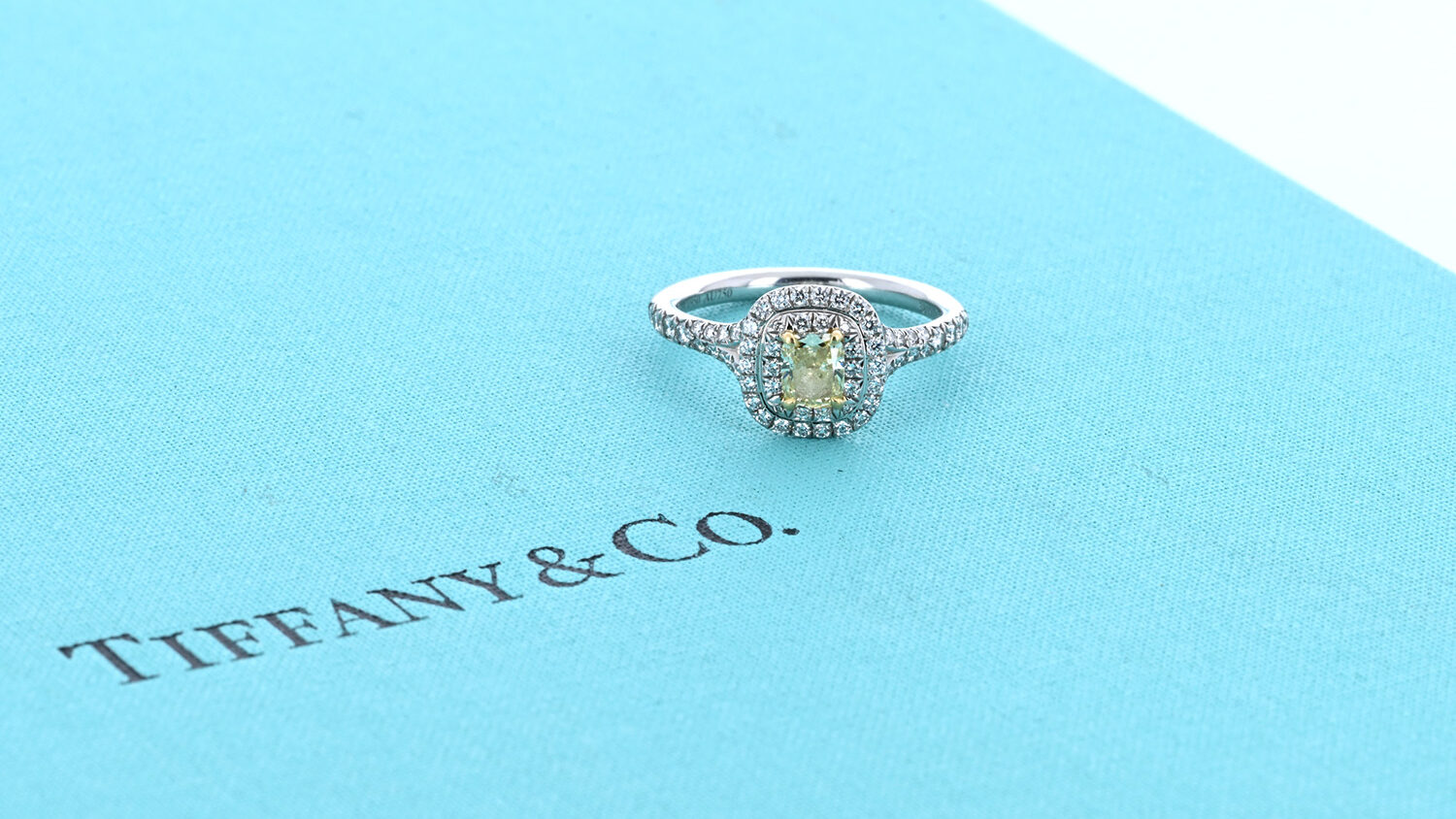 engagement ring on top of tiffany & co box