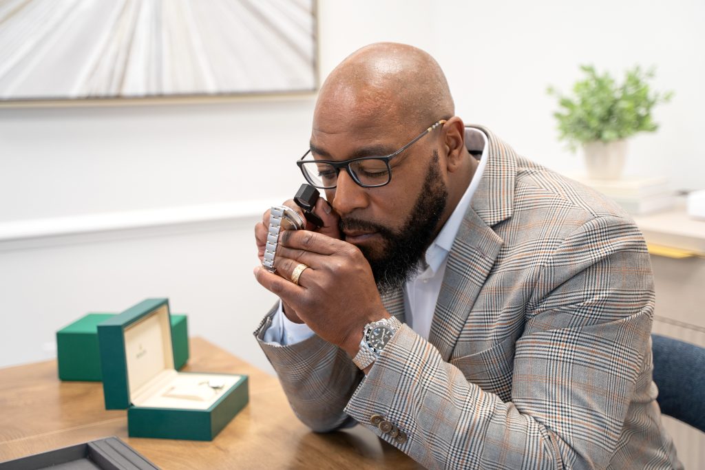 Mia Cossey, Market Director at Diamond Banc examining jewelry with a client