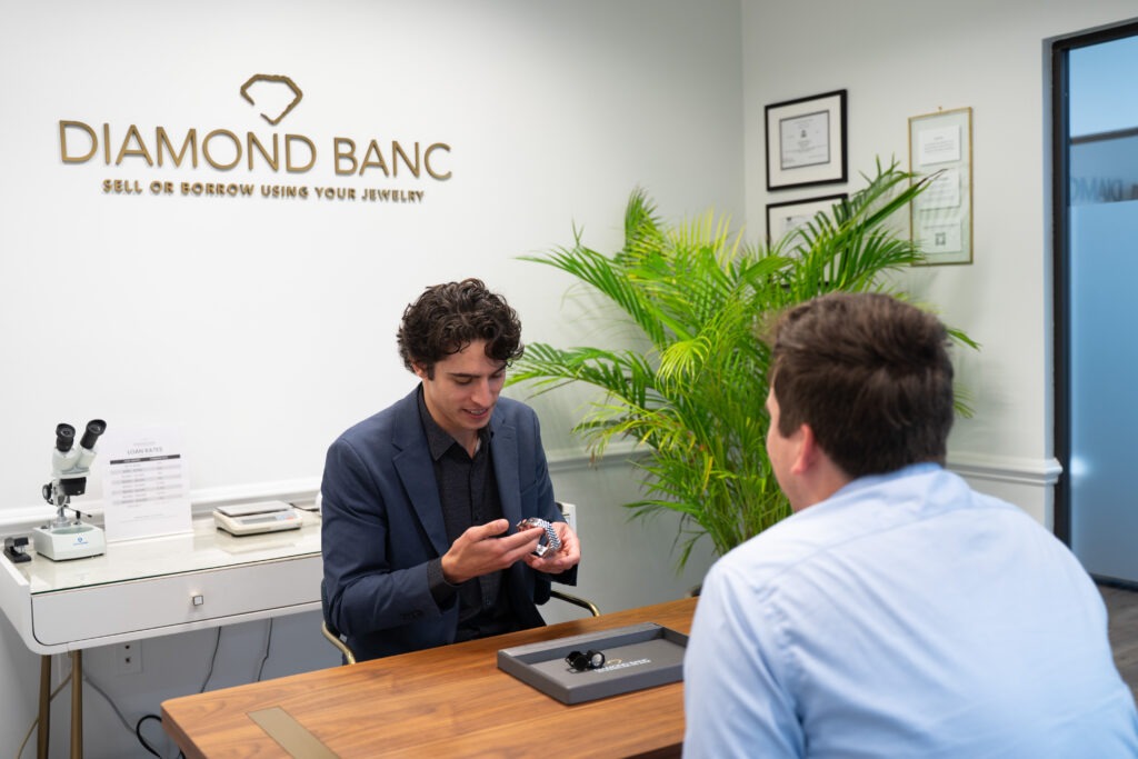 aventura jewelry buyer evaluating a rolex watch with a client