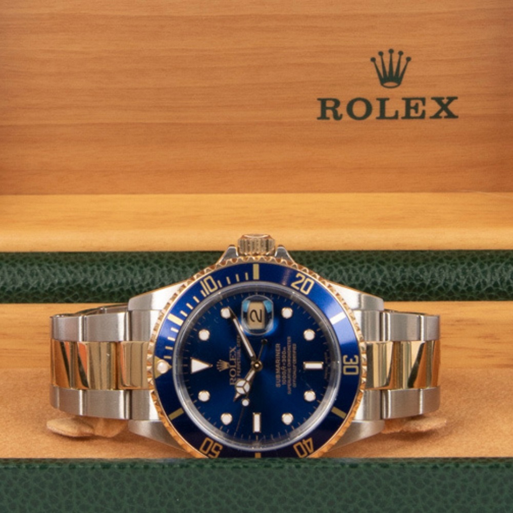 	
A close-up of a classic Rolex GMT-Master wristwatch with a red and blue bezel, stainless steel band, and black dial, worn on a person's wrist.