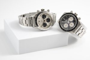 Vintage Rolex Daytona Cosmograph watches with silver and black dials on white display