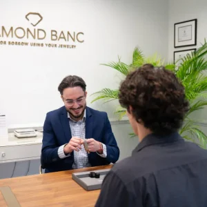 Diamond Banc employee checking a Rolex watch at the Diamond Banc Coral Gables office