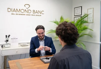 Diamond Banc employee checking a Rolex watch at the Diamond Banc Coral Gables office