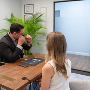 A Diamond Banc evaluator and client reviewing jewelry during a Coral Gables office consultation