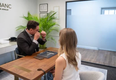 A Diamond Banc evaluator and client reviewing jewelry during a Coral Gables office consultation