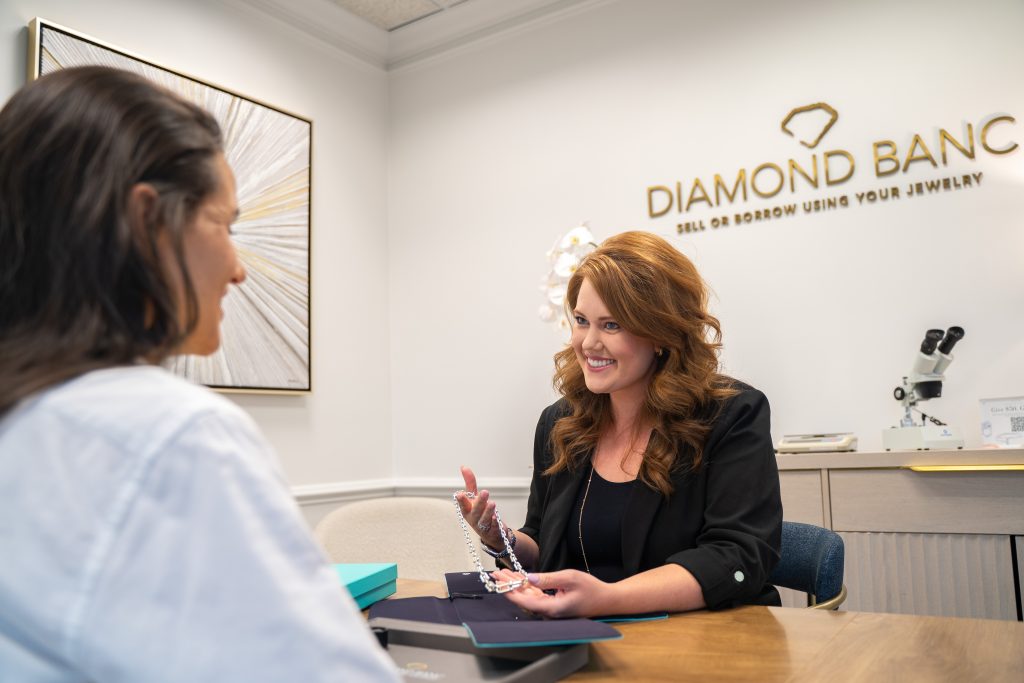 Jenna Bolton, Buyer & Lender in Roswell, GA, meeting with a client at her desk